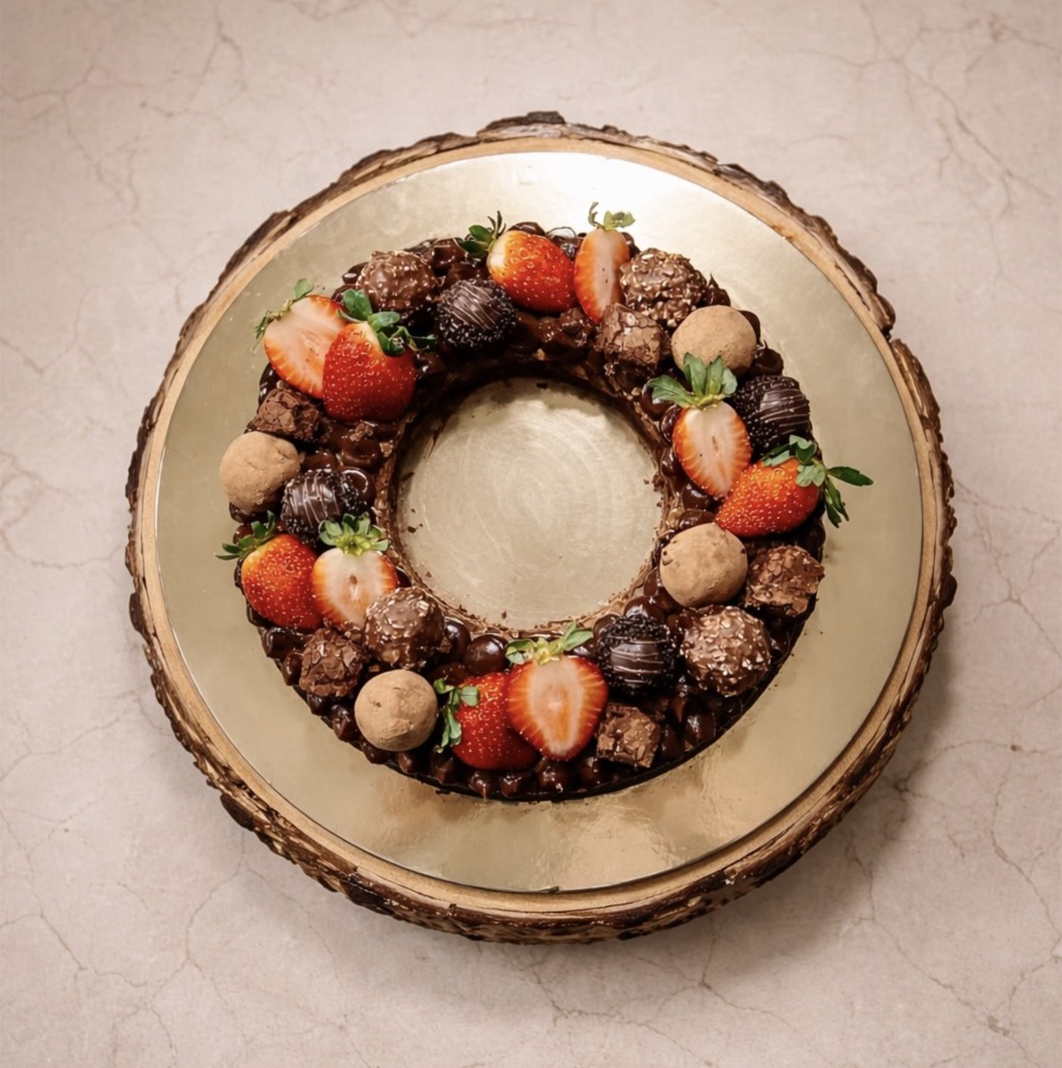 Chocolate wreath cake with strawberries and truffles