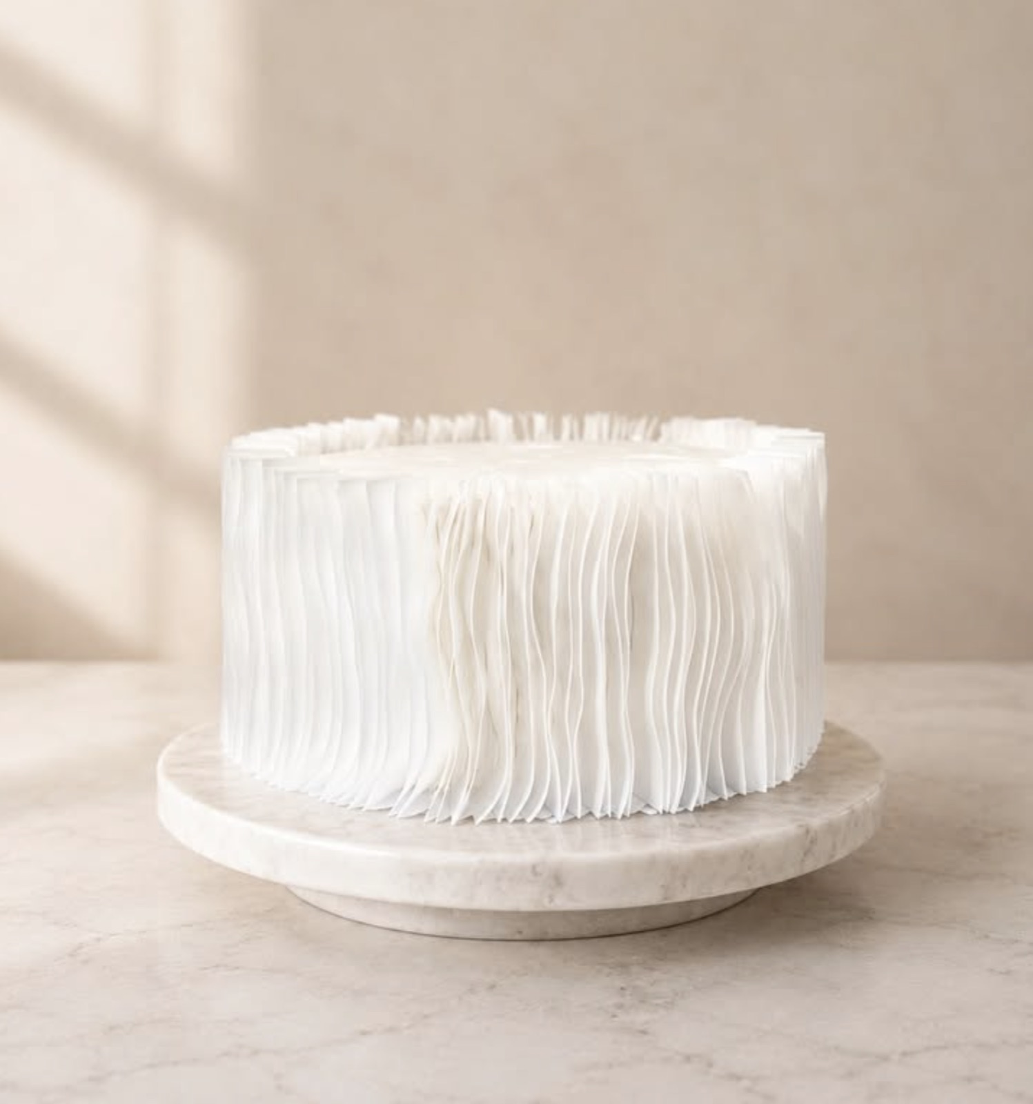 LEVAN signature pleated cake on a marble stand